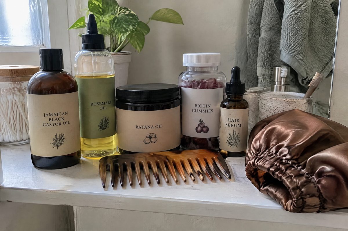 A bathroom shelf full of hair oils and gummies